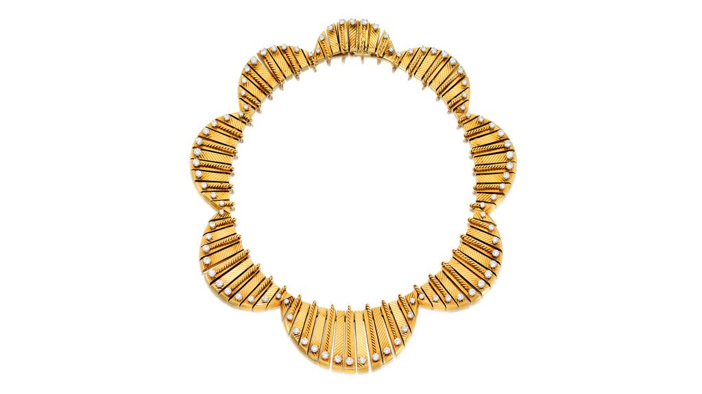 This necklace by Cartier, circa 1953, features a gold wave fringe design set with diamonds. Cartier 1953 diamond necklace, “Méandres-Bavoir”